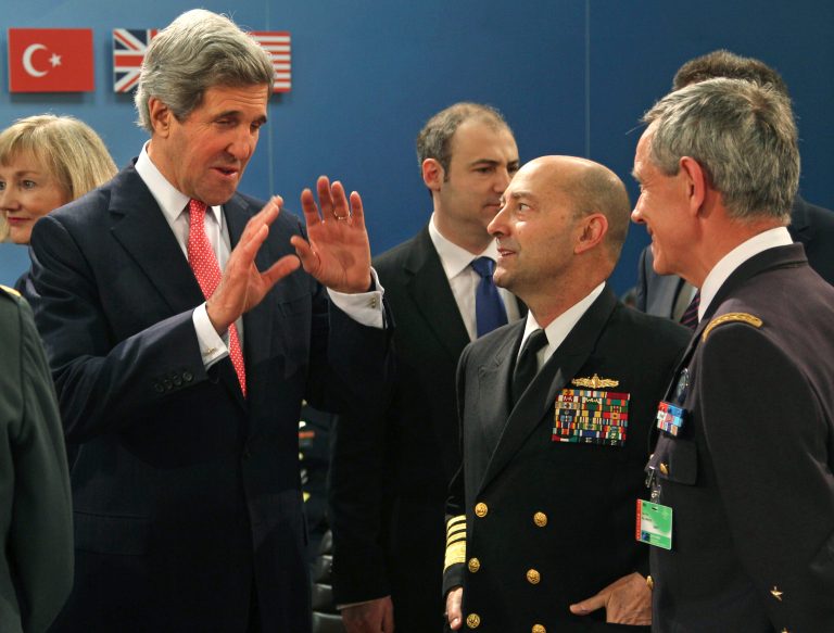U.S. Secretary of State John Kerry, left, talks with NATO Supreme Allied Commander in Europe Adm. James Stavridis, center, during a meeting at NATO headquarters in Brussels, Tuesday, April 23, 2013. Foreign ministers from the 28 NATO countries are meeting in Brussels to discuss the wars in Syria and Afghanistan, and to learn the views of a new member of their club — U.S. Secretary of State John Kerry. (AP Photo/Yves Logghe)