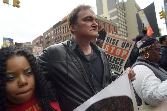 "When I see murders, I do not stand by ... I have to call a murder a murder and I have to call the murderers the murderers," Tarantino told the crowd. (AP Photo/Patrick Sison)