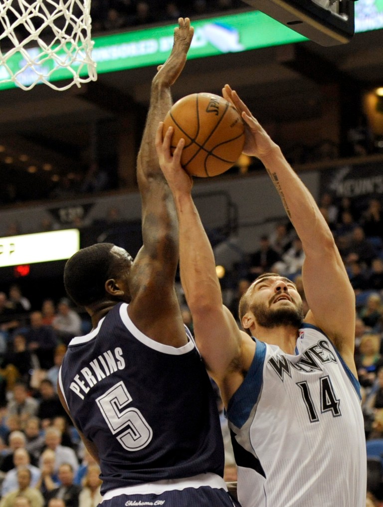   Minnesota Timberwolves' Nikola Pekovic (14), of Montenegro, shoots against Oklahoma City Thunder's Kendrick Perkins (5) during the first quarter of an NBA basketball game at the Target Center on Thursday, Dec. 20, 2012, in Minneapolis. (AP Photo/Hannah Foslien)  