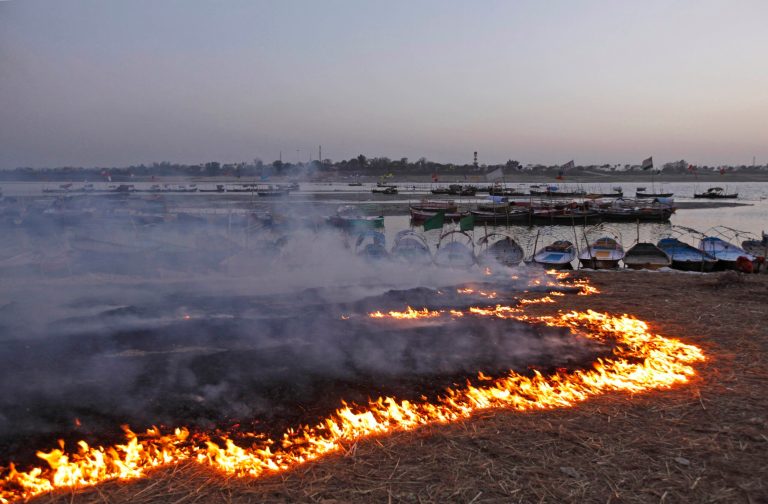 FILE- In this March 18, 2013 file photo, a trail of fire lines the banks after piles of garbage were set afire at the end of the Mahakumbh mela festival at the confluence of rivers the Ganges and the Yamuna in Allahabad, India. A new study shows that rampant trash-burning is releasing more polluting emissions than governments are reporting.The researchers estimate about 41 percent of the world's garbage is burned in backyards, fields, dumps or incinerators. (AP Photo/ Rajesh Kumar Singh, file)