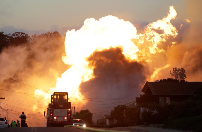 FILE - In this Sept. 9, 2010, file photo, a massive fire roars through a mostly residential neighborhood in San Bruno, Calif. Pacific Gas & Electric Co. pleaded not guilty Monday, April 21, 2014, to a dozen felony charges stemming from alleged safety violations in a deadly 2010 natural gas pipeline explosion that leveled a suburban neighborhood in the San Francisco Bay Area. As survivors of the blast looked on, attorneys for California's largest utility entered the plea in federal court in San Francisco to 12 felony violations of federal pipeline safety laws. (AP Photo/Paul Sakuma, File)
