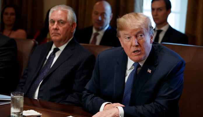 According to a report, President Trump (pictured left) complained during an Oval Office meeting in June about immigrants, going so far as to say Haitians "all have AIDS," among other comments. The White House has since denied the claims as "outrageous." (AP Photo/Evan Vucci)