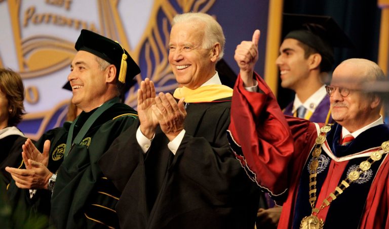 Vice President Joe Biden, center, smiles after arriving for a graduation ceremony at the Miami Dade College in Miami, Saturday, May 3,2014.   Biden said a 