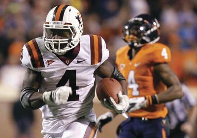 Steve Helber/AP
Virginia Tech running back David Wilson rushed for 153 yards and two touchdowns on 24 carries in the Hokies'38-0 victory over Virginia on Saturday.