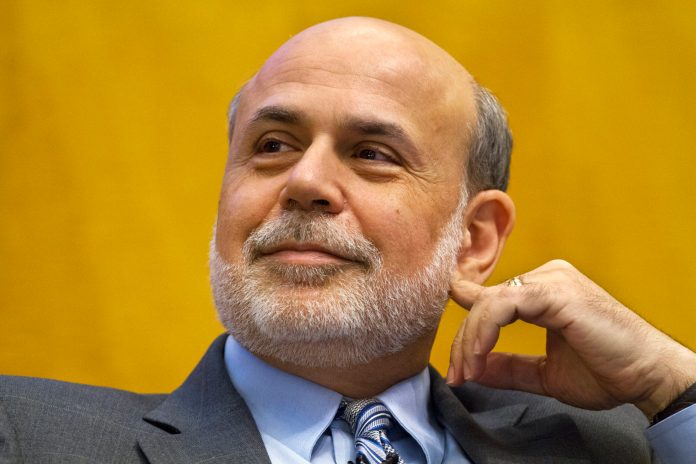 Federal Reserve Chairman Ben Bernanke listens while participating in a panel at the International Monetary Fund (IMF) in Washington Friday, Nov. 8, 2013, on "The Crisis as a Classic Financial Panic."  Bernanke said the Federal Reserve is drafting rules to close large insolvent banks without bringing down the broader financial system, one of many steps regulators must take to prevent another financial crisis.  (AP Photo/Jacquelyn Martin)