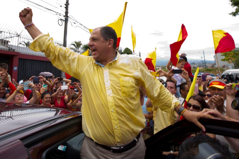 Luis Guillermo Solis, presidential candidate for the Citizen's Action Party, waves to supporters after casting his vote in the presidential runoff election in San Jose, Costa Rica, Sunday, April 6, 2014. Solis' only rival in the runoff dropped out of the race last month, leaving Solis one remaining challenge: getting enough Costa Ricans to the polls to give him a respectable vote total. (AP Photo/Moises Castillo)