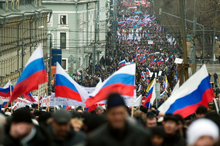 More than ten thousand pro-Kremlin demonstrators many holding Russian flags march in central Moscow, Russia, Sunday, March 2, 2014 to express support for the latest developments in Russian-Ukrainian relations. (AP Photo/Pavel Golovkin)