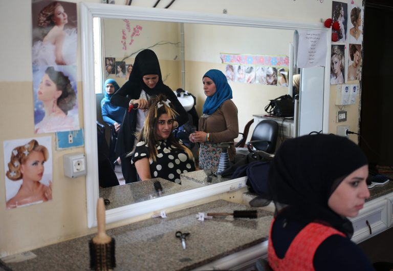 In this photo taken on May 29, 2014, Syrian refugee women attend a hair dressing class where they obtain crucial training to find jobs in a community center in Halba, north Lebanon. Across the region women lead about a quarter of all Syrian refugee families, which number some 145,000, the United Nations estimated in a report issued Tuesday, July 8, 2014. (AP Photo/Hussein Malla)