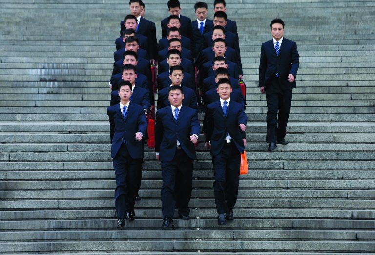 Chinese soldiers dressed as ushers march Wednesday, Nov. 7, 2012, at the Great Hall of the People in Bejing, China, where the Chinese Communist Party's 18th National Congress is scheduled to begin Thursday. The once-a-decade event installs a new leadership to run the world's second largest economy and newly assertive global power. (AP Photo/Vincent Yu)
