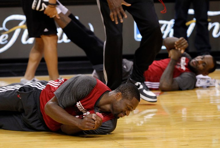   Miami Heat shooting guard Dwyane Wade, left, and small forward LeBron James stretch during practice Saturday, June 16, 2012, in Miami. The Heat play the Oklahoma City Thunder in Game 3 of the NBA basketball finals on Sunday. (AP Photo/Alan Diaz)  