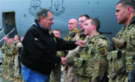 Defense Secretary Leon Panetta looks at a name tag as he meets with troops at Kabul International Airport in Kabul, Afghanistan earlier this month. The Army is under pressure to fix problems in its military payroll system for troops, including those in Afghanistan. (AP Photo/Susan Walsh)