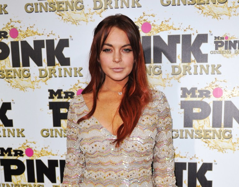   FILE - In this Oct. 11, 2012 file photo, Lindsay Lohan attends the Mr. Pink Ginseng launch party at the Beverly Wilshire hotel in Beverly Hills, Calif. Los Angeles city prosecutors said Tuesday Dec. 11, 2012 that they will seek to revoke Lohan's probation because the actress has been charged with three misdemeanors stemming from a June car crash. (Photo by Richard Shotwell/Invision/AP, File)  