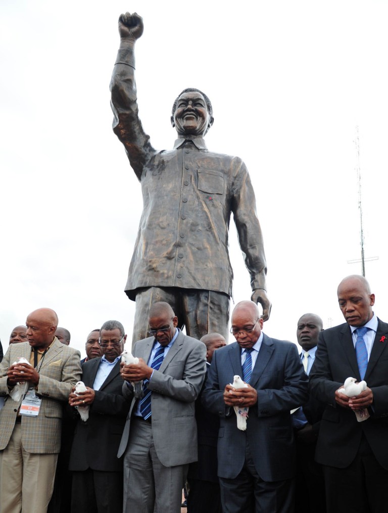   CORRECTS YEAR A giant statue of former president Nelson Mandela after being unveiled on Naval Hill in Bloemfontein, South Africa, Thursday, Dec 13, 2012, by president Jacob Zuma, second from right, ahead of the ruling African National Congress's elective conference. Mandela, who has been hospitalized since the weekend, is recovering from a lung infection. (AP Photo)  