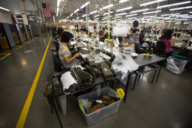 In this Sept. 19, 2014 photo, workers assemble body armor in the sewing area in the Point Blank Body Armor factory in Pompano Beach, Fla. The Commerce Department releases its report on August durable goods orders on Thursday, Sept. 25, 2014. (AP Photo/J Pat Carter)
