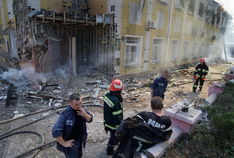 Ukrainian fire fighters have a break as they put out the fire at the destroyed building after shelling in Donetsk, eastern Ukraine, Sunday, Aug. 10, 2014. Fighting raged Sunday in the eastern Ukrainian city of Donetsk despite a request from the pro-Russian rebels there for a cease-fire to prevent a 