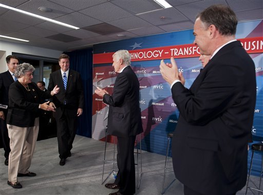 Virginia Senate candidates, former Gov. Tim Kaine, Democrat, right, and Northern Virginia Technology Council Vice Chairman Jim Shaeffer, center, applaud as his opponent, former Gov. and senator George Allen, Republican, center left, walks onstage during the Northern Virginia Technology Council's Tech Town Hall in Reston, Va., Thursday, June 28, 2012. (AP Photo/Cliff Owen)