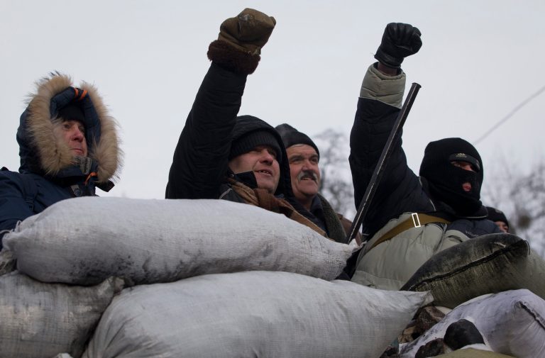 Protesters chant slogans at the barricade in central Kiev, Wednesday, Jan. 29, 2014. Ukraine's parliament is considering measures to grant amnesty to those arrested during weeks of protests in the crisis-torn country, but possibly with conditions attached that would be unacceptable to the opposition. (AP Photo/Darko Bandic)