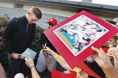 Patrick Semansky/AP
The fanfare surrounding Stephen Strasburg is expected to generate millions in additional revenue.