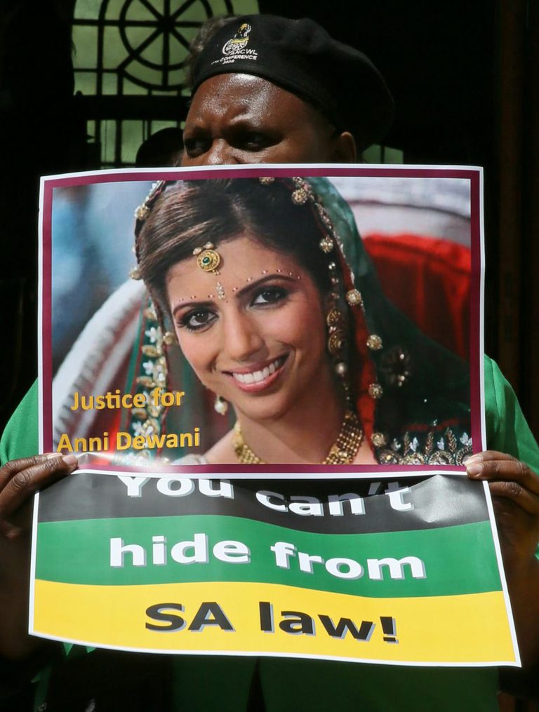 A protester holds a placard with a portrait of the late Anni Dewani that reads 