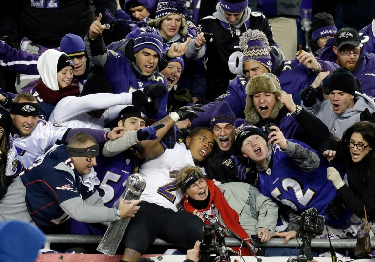 FILE - In this Jan. 20, 2013, file photo, Baltimore Ravens running back Ray Rice, center, is surrounded by fans in the stands as he celebrates winning the NFL football AFC Championship football game against the New England Patriots in Foxborough, Mass. Rice was let go by the Ravens on Monday, Sept. 8, 2014, and suspended indefinitely by the NFL after a video was released that appears to show the running back striking his then-fiancee in February. (AP Photo/Steven Senne)