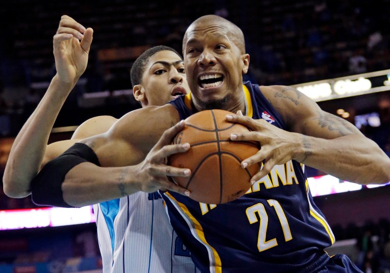   Indiana power forward David West (21) goes to the basket as New Orleans power forward Anthony Davis (23) defends in the first half of a NBA basketball game at the New Orleans Arena in New Orleans Saturday, Dec. 22, 2012. (AP Photo/Dave Martin  