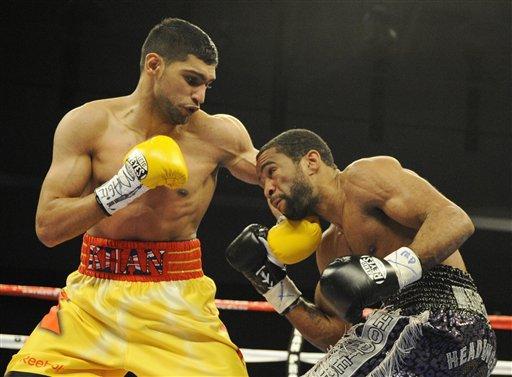 In this Dec. 10, 2011 file photo, Amir Khan, left, of England, fights Lamont Peterson during a boxing match in Washington. (AP Photo/Nick Wass, File)