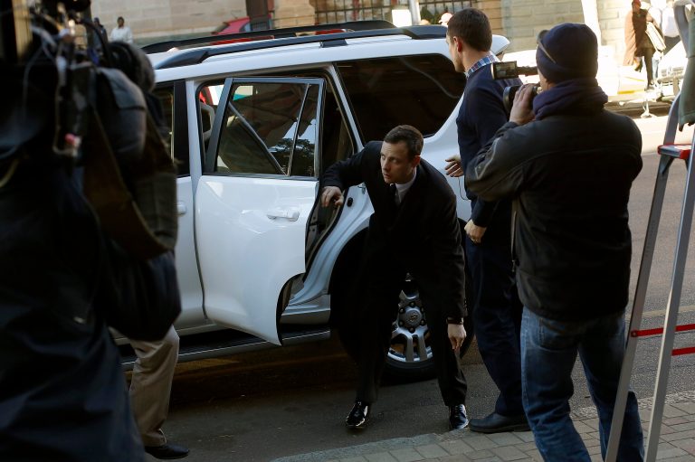 Oscar Pistorius arrives at court in Pretoria, Tuesday, July 8, 2014. Chief prosecutor Gerrie Nel has challenged the credibility of a physician, Wayne Derman, who testified that the athlete has an anxious nature linked to his disability and could not be objective about the double-amputee runner because he had treated Pistorius over many years and traveled with him extensively. (AP Photo/Jerome Delay)
