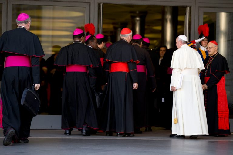 Pope Francis, right, arrives with bishops and cardinals to attend an afternoon session of a two-week synod on family issues at the Vatican, Saturday, Oct. 18, 2014. Catholic bishops predicted widespread approval Saturday of a revised document laying out the church's position on gays, sex, marriage and divorce, saying the report is a 
