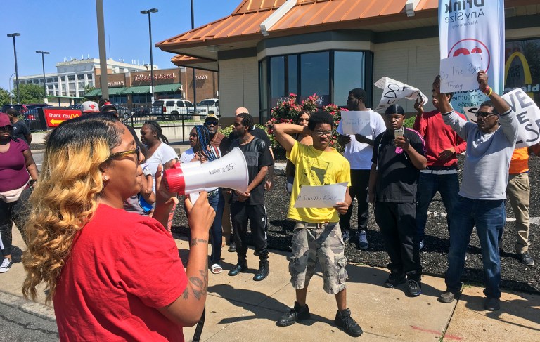 In this Thursday, Aug. 24, 2017, photo, Gennice Mackey uses a bullhorn to lead a chant of 