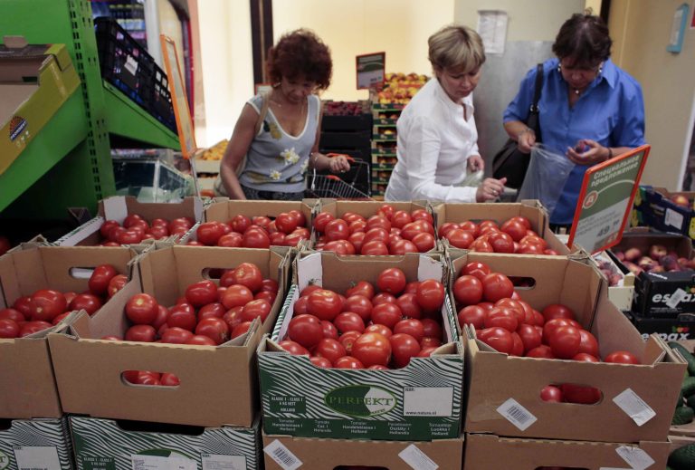Women choose Dutch tomatoes at a supermarket in downtown Moscow, on Thursday, Aug. 7, 2014. The Russian government has banned all imports of meat, fish, milk and milk products and fruit and vegetables from the United States, the European Union, Australia, Canada and Norway, Prime Minister Dmitry Medvedev announced Thursday. The move was taken on orders from President Vladimir Putin in response to sanctions imposed on Russia by the West over the crisis in Ukraine. The ban has been introduced for one year. (AP Photo/Ivan Sekretarev)