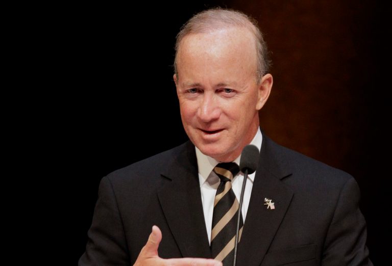Daniels, now the president at Purdue University, will emcee the event on Sept. 1. (AP Photo/Michael Conroy, File)