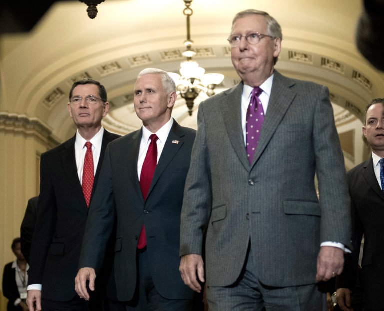 Senate Majority Leader Mitch McConnell, right, organized passage of a resolution early Thursday morning that will serve as a vehicle for repealing Obamacare. (AP Photo/Cliff Owen)