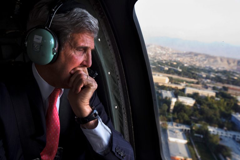 U.S. Secretary of State John Kerry looks out the window en route to the ISAF headquarters after arriving on an unannounced visit in Kabul, Afghanistan, Friday, Oct. 11, 2013. Kerry flew to Afghanistan Friday for urgent talks with Afghan President Hamid Karzai as an end of October deadline looms for completing a security deal that would allow American troops to remain in Afghanistan after the end of the NATO-led military mission next year. (AP Photo/Jacquelyn Martin, Pool)
