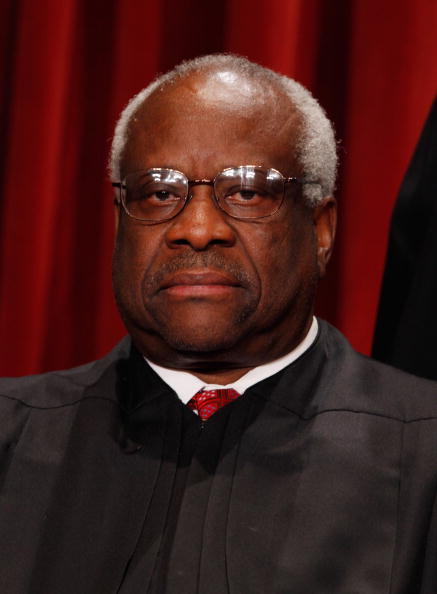 WASHINGTON - OCTOBER 08:  U.S. Supreme Court Associate Justice Clarence Thomas poses for photographs in the East Conference Room at the Supreme Court building October 8, 2010 in Washington, DC. This is the first time in history that three women are simultaneously serving on the court.  (Photo by Chip Somodevilla/Getty Images)