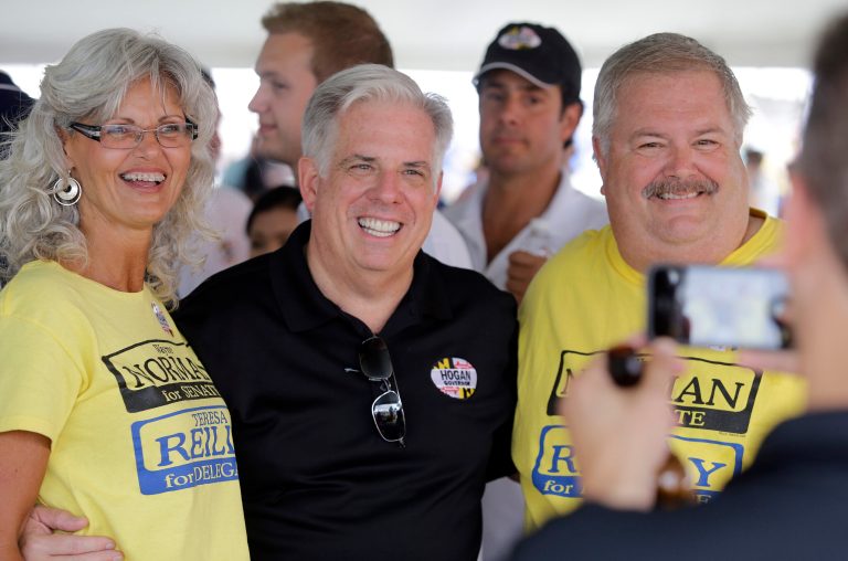 FILE - In this July 16, 2014, file photo, Maryland Republican gubernatorial candidate Larry Hogan, center, poses for a picture at the 38th Annual J. Millard Tawes Crab and Clam Bake in Crisfield, Md.  Hogan and Maryland Democratic gubernatorial candidate, Lt. Gov. Anthony Brown have not provided a look into their personal finances after repeated requests to their campaigns by The Associated Press for more than two months to view their tax returns.  Candidates are not required by law to make tax returns public. However, candidates in other states often have made at least some of their returns available for review in a gesture of transparency. (AP Photo/Patrick Semansky, File)