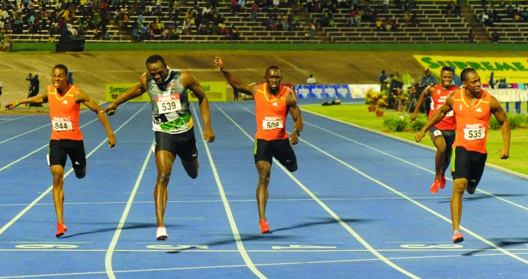 Sprinter Yohan Blake, far right, crosses the finish line ahead of world-record holder Usain Bolt, second from left, Nickel Ashmeade, center, Warren Weir, left, and Jason Young to win the 200m final at Jamaica's Olympic trials in Kingston, Jamaica, Sunday, July 1, 2012. Blake edged Bolt by 0.03 finishing in 19.80 seconds. (AP Photo/Collin Reid)