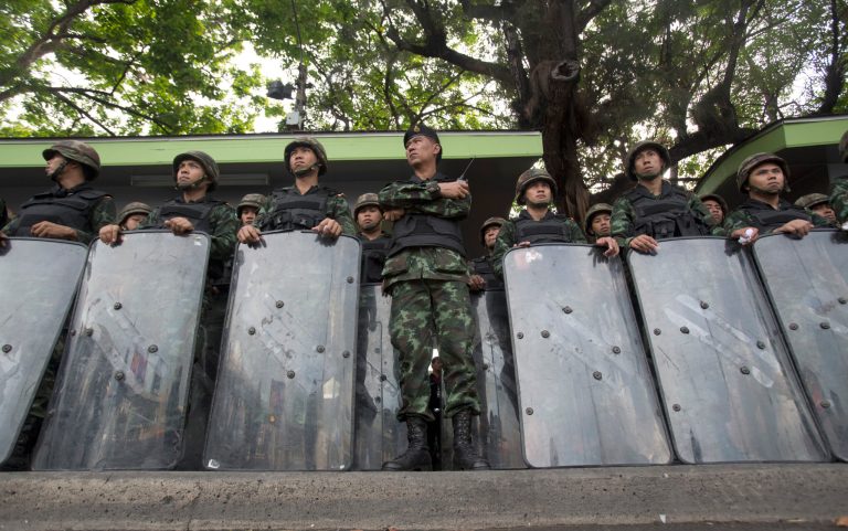 Thai soldiers stand guard at Victory Monument in Bangkok, Thailand Thursday, May 29, 2014.  Hundreds of Thai troops and police sealed off one of Bangkok's busiest intersections Thursday in an attempt to block a planned protest one week after a military coup.  (AP Photo/Sakchai Lalit)