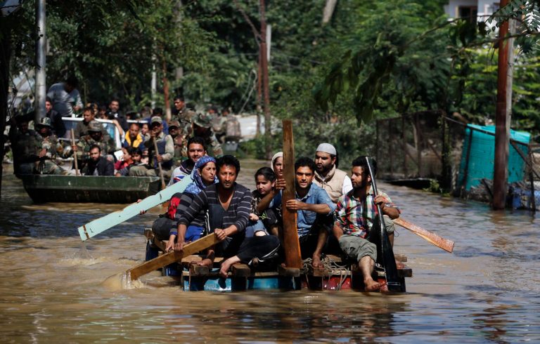 Kashmiri residents use makeshift rafts to rescue flood affected people in Srinagar, in Indian-controlled Kashmir, Wednesday, Sept.10, 2014. Raging monsoon floods sweeping across India and Pakistan have killed more than 440 people, authorities said Tuesday, warning hundreds of thousands more to be prepared to flee their homes as helicopters and boats raced to save marooned victims. (AP Photo/Altaf Qadri)