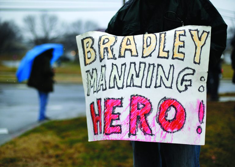 A demonstrator holds a sign in support of Army Pfc. Bradley Manning outside of Fort Meade, Md., Tuesday, Nov. 27, 2012, where Manning is scheduled to appear for a pretrial hearing. Manning is accused of sending hundreds of thousands of classified Iraq and Afghanistan war logs and more than 250,000 diplomatic cables to the secret-spilling website WikiLeaks while he was working as an intelligence analyst in Baghdad in 2009 and 2010. (AP Photo/Patrick Semansky)