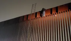 Smugglers leave man stranded atop southern border’s 30-foot wall