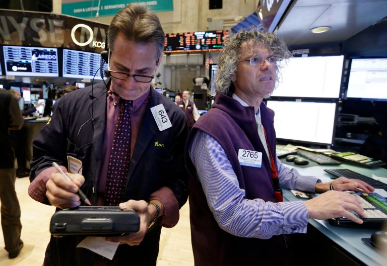 Trader Ronald Madarasz, left, and specialist Donald Civitanova work on the floor of the New York Stock Exchange Thursday, April 10, 2014.  U.S. stock indexes are slipping lower in early trading Thursday as investors pick over a mixed batch of corporate earnings reports. (AP Photo/Richard Drew)