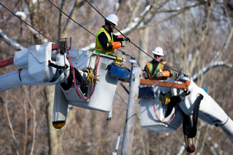 Linesmen work to restore electrical power, Friday, Feb. 7, 2014, in Downingtown, Pa. A small army of electricity restoration crews labored Friday to reconnect about 330,000 customers in Pennsylvania and Maryland.  (AP Photo/Matt Rourke)