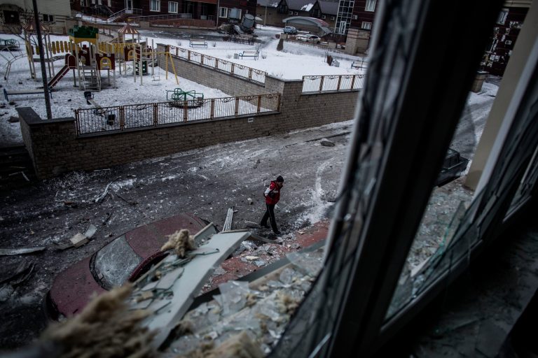 A Ukrainian man walks through the debris produced after the Ukrainian Army hit a building in Voroshilovsky area, center of Donetsk, Ukraine. (AP/Manu Brabo)