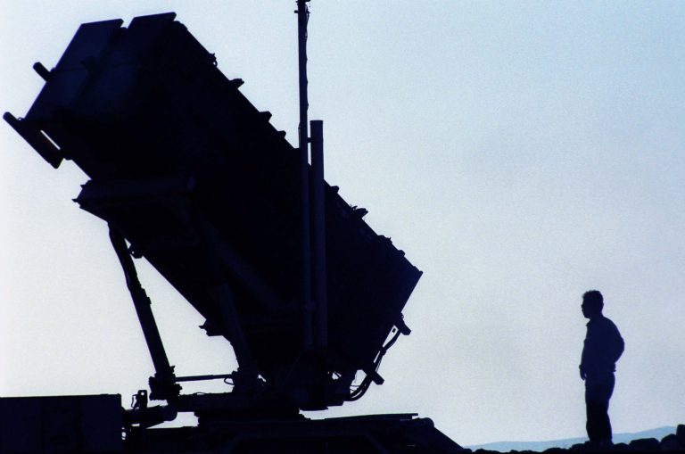 An Israeli soldier stands next to a unit of newly-deployed Patriot anti-missile missiles near Israel's nuclear research reactor August 25, 2002 at Dimona in the Negev desert, Israel. (Photo by Nadav Neuhaus/Getty images)