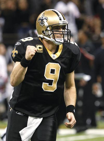 New Orleans Saints quarterback Drew Brees(9)celebrates his touchdown pass to wide receiver Robert Meachem in the third quarter of an NFL football game against the Atlanta Falcons in New Orleans, Monday, Dec. 26, 2011.(AP Photo/Bill Haber)