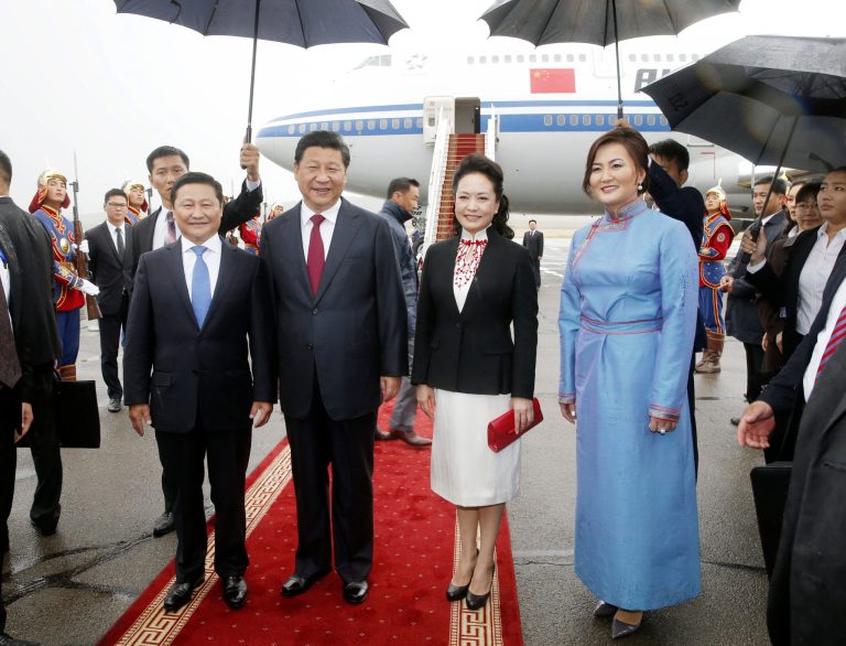 In this photo released by China's Xinhua news agency, Chinese President Xi Jinping, center left, and his wife Peng Liyuan, center right, pose for a photo with Mongolian Prime Minister Norov Altankhuyag and his wife Khonichin Selenge at Ulan Bator airport, Mongolia, Thursday, Aug. 21, 2014. Landlocked Mongolia is hoping to secure better access to Chinese ports as Xi became the first Chinese head of state in more than a decade to visit this sprawling nation sandwiched between China and Russia. (AP Photo/Xinhua, Ju Peng) NO SALES