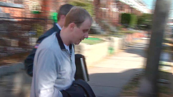 In this image taken from video and released by WJLA TV, U.S. Postal police walk with Ryan Loskarn, center, chief of staff for U.S. Sen. Lamar Alexander, Wednesday, Dec. 11, in Washington D.C. (AP Photo/WJLA TV)