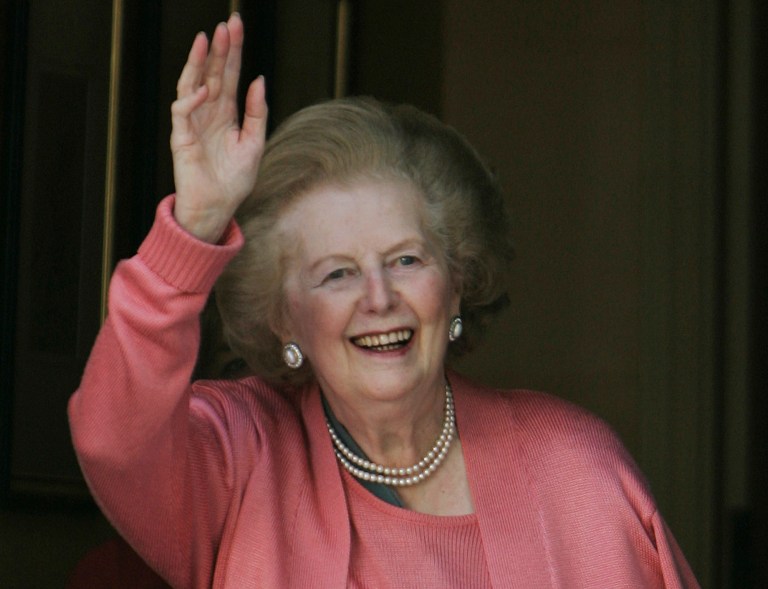 Former British Prime Minister Margaret Thatcher gestures to members of the media following her return home from hospital suffering from a broken arm, in central London, in this file photo dated Monday June 29, 2009. 