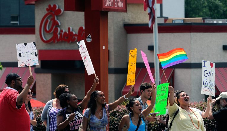 Gay rights groups and others protest and hold a "kiss-in" outside a Chick-fil-A restaurant.