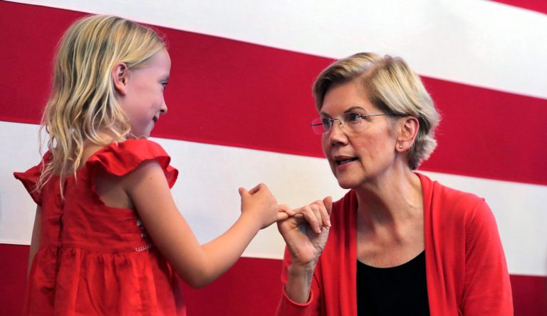 Democratic presidential candidate Sen. Elizabeth Warren, right, makes a pinky promise as she chats with Sydney Hansen, 8, of Oakland, California.